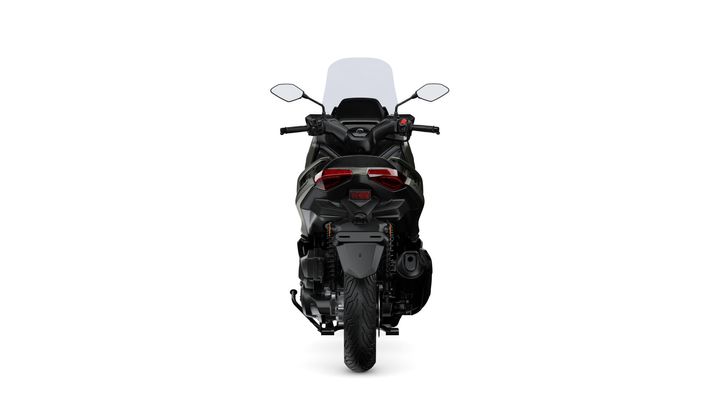 A rear view of a modern black motorcycle with a windshield, featuring sleek tail lights and a prominent rear tire on a white background.