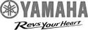Yamaha logo featuring the brand name in bold red letters and the tagline "Revs Your Heart" in a stylized font.
