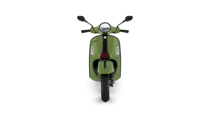 Front view of a green scooter with a round headlight, black handlebars, and a sleek, modern design.