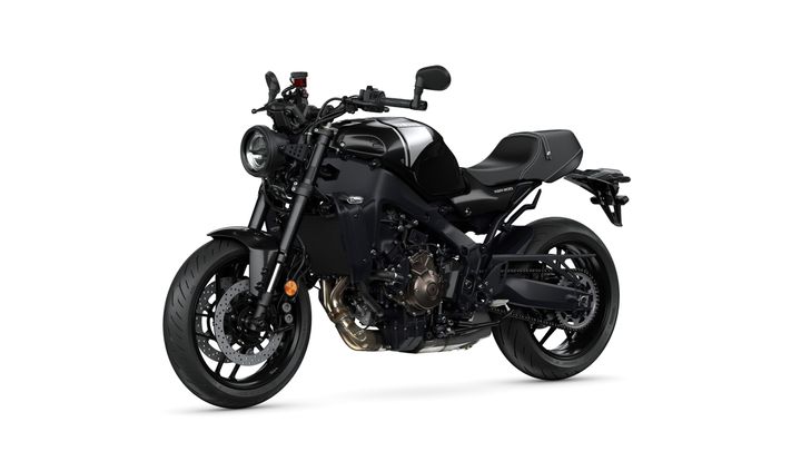 A sleek black motorcycle with a modern design, featuring a prominent front headlight, a sporty frame, and distinctive detailing on the fuel tank and seat.