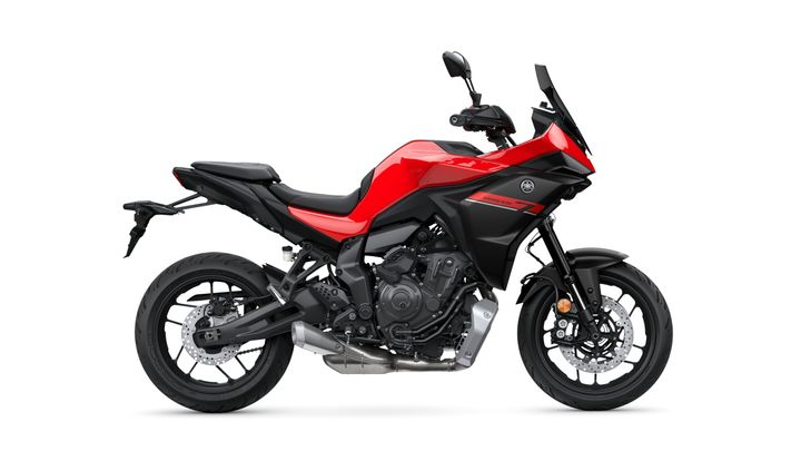 A red and black Yamaha motorcycle is shown from the side, showcasing its sleek design, sporty features, and modern components.