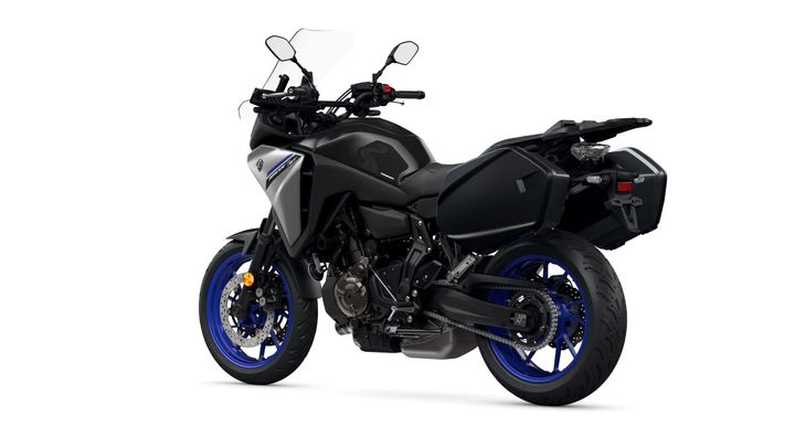 A sleek black motorcycle with blue wheels and a silver accent, featuring a tall windshield, dual mirrors, and a side luggage compartment, positioned on a white background.