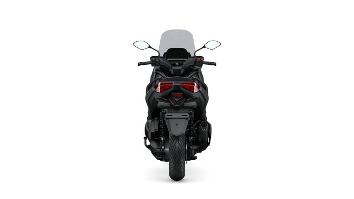 Rear view of a black motorcycle with a sleek design, showing the seat, mirrors, and dual red taillights against a white background.