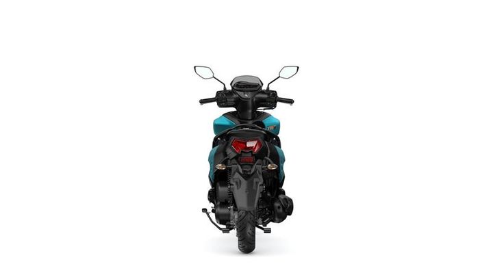 A rear view of a stylish blue and black scooter, showcasing the seat, handlebars, and taillight against a white background.