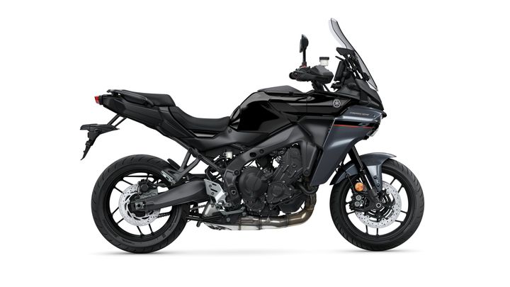 A sleek black motorcycle viewed from the side, featuring a prominent body design, sporty accents, and detailed mechanics including a dual exhaust and disc brakes.