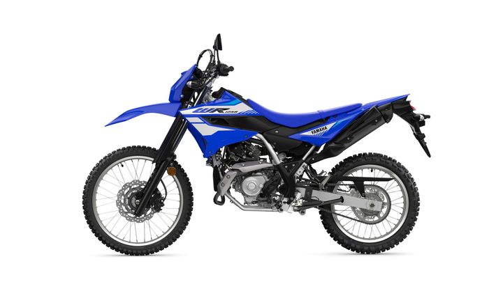 A blue Yamaha WR dirt bike is displayed from the side, showcasing its rugged design, off-road tires, and intricate components.