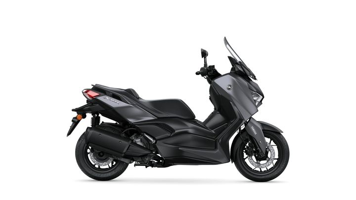 A sleek black Yamaha XMAX scooter is shown from the side, featuring a streamlined design, prominent windscreen, and dual-colored body accents.
