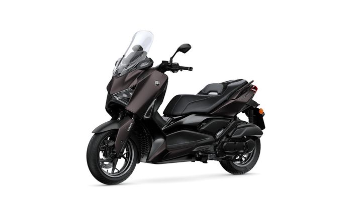 A sleek, dark brown Yamaha scooter featuring a tall windscreen, comfortable seating, and sporty design elements, displayed at a slight angle.