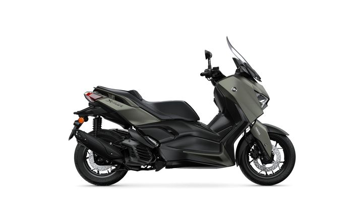 A sleek, modern scooter in an olive green finish, viewed from the side, showcasing a streamlined design, large front wheel, and comfortable seat.
