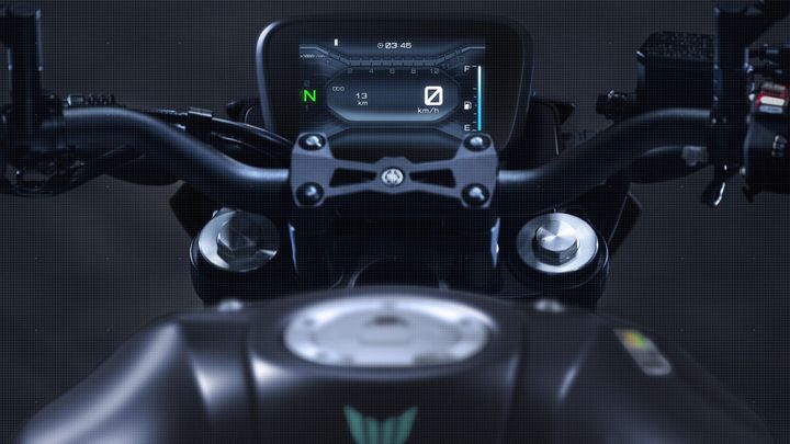 Close-up view of a motorcycle's dashboard display and handlebars, showing the speedometer, odometer, and time indicators against a dark background.