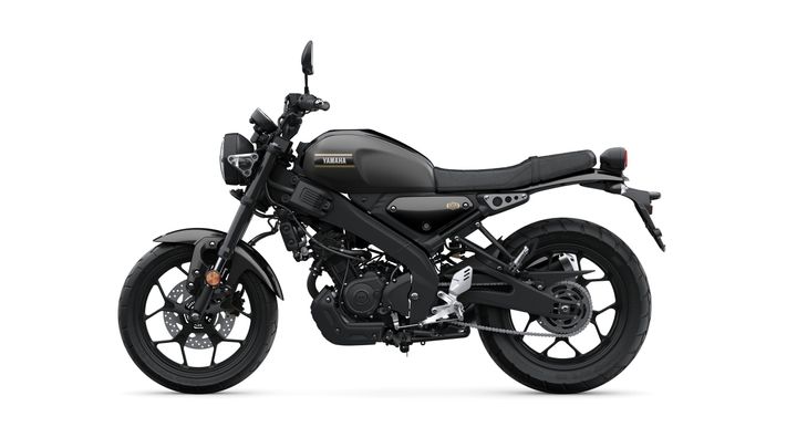 A sleek, black Yamaha motorcycle shown from the side, featuring a minimalist design, a low seat, and prominent tires, set against a white background.