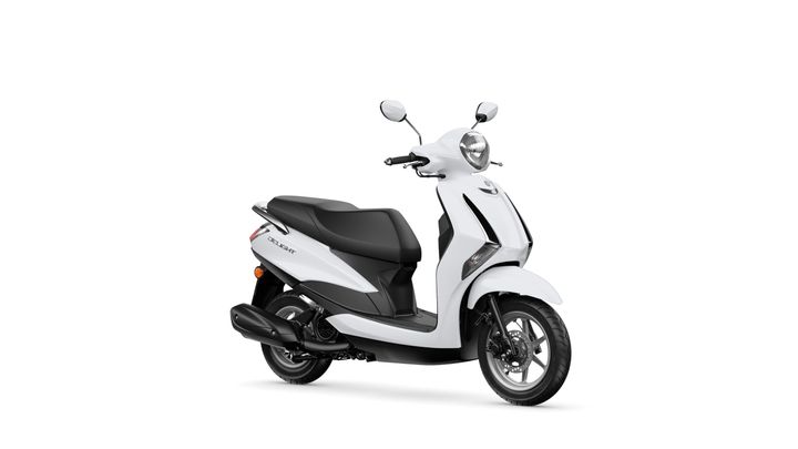 Yamaha 2024 Delight A sleek white scooter with a black seat, featuring a round headlight and two mirrors, positioned at an angle to show its side profile.