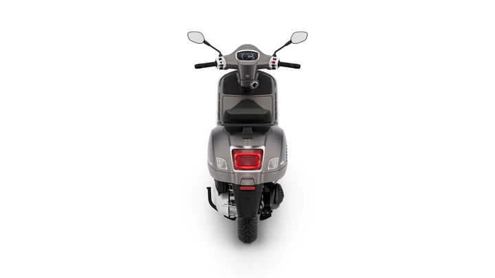 A rear view of a sleek gray scooter, showcasing its tail light, seat, and mirrors against a white background.