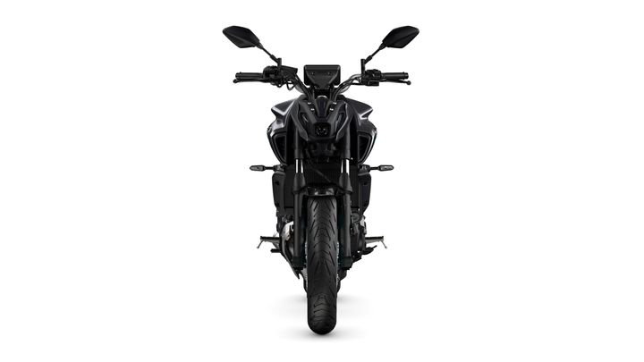 A front view of a black motorcycle showcasing its sleek design, headlight, handlebars, and wide front tire against a white background.