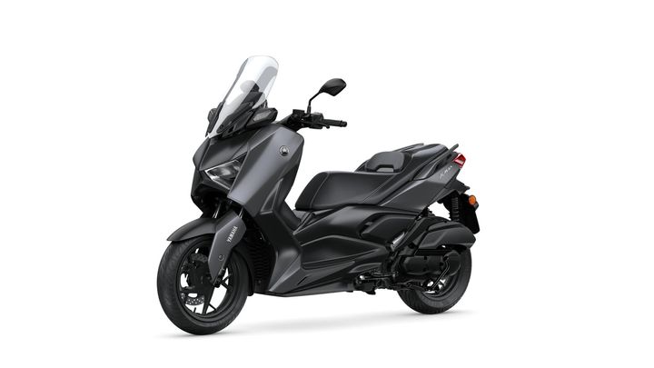 A sleek black Yamaha scooter with a prominent windshield, positioned at an angle to showcase its modern design and features.