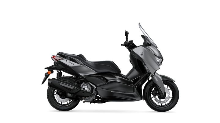 A sleek, dark grey Yamaha XMAX scooter shown from the side, featuring a modern design with a tall windshield, sporty seat, and intricate bodywork.