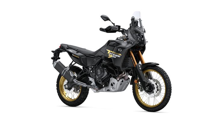 A black and gold adventure motorcycle with rugged tires, a tall windshield, and a sturdy frame, positioned on a white background.