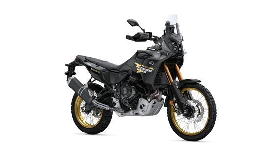 A black and gold adventure motorcycle with rugged tires, a tall windshield, and a sturdy frame, positioned on a white background.