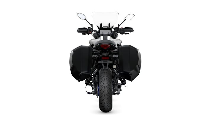 A rear view of a motorcycle with black side panniers, a clear windscreen, and a modern design, set against a white background.