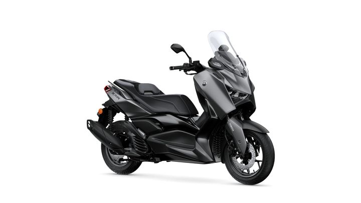 Yamaha 2026 XMAX 125 Tech MAX+ A sleek, modern gray scooter with a prominent front windshield, comfortable seat, and sporty design, showcasing its side profile against a white background.