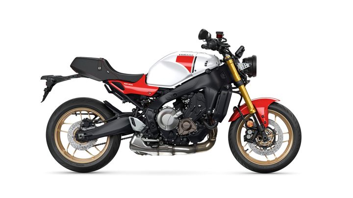 A sleek Yamaha motorcycle in a striking white and red color scheme, featuring a sporty design with a prominent gold front fork and black accents, displayed against a clean white background.