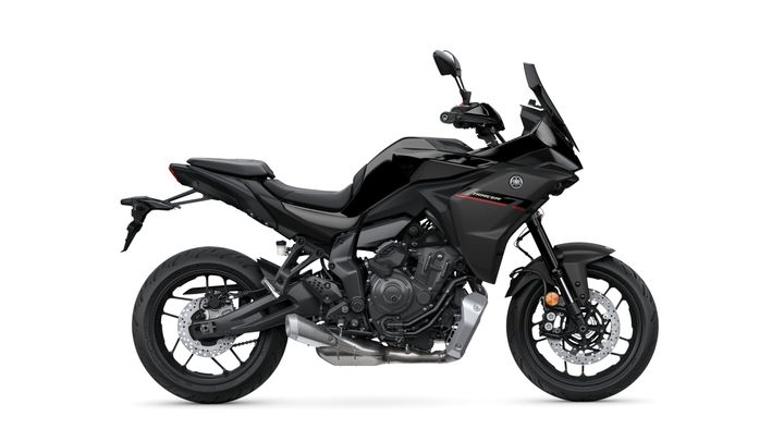 A sleek black motorcycle with a sporty design, featuring a prominent engine, double disc brakes, and aerodynamic fairings, displayed against a white background.