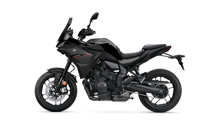 A sleek black motorcycle with a sporty design, featuring a fairing, dual front disc brakes, and a low seat, set against a plain white background.
