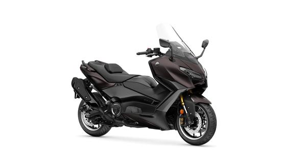 A sleek black and brown touring motorcycle, featuring a large windshield, comfortable seat, and modern design, positioned on a white background.