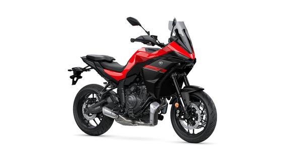 Yamaha 2026 Tracer 7 A sleek red and black motorcycle with a sporty design, featuring a fairing, windscreen, and dual headlights, parked on a white background.