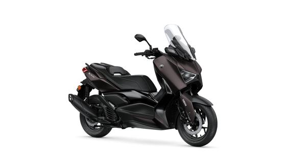Yamaha 2024 XMAX 125 Tech MAX A sleek, dark brown Yamaha XMAX scooter with a large windshield, featured from a side angle on a plain white background.