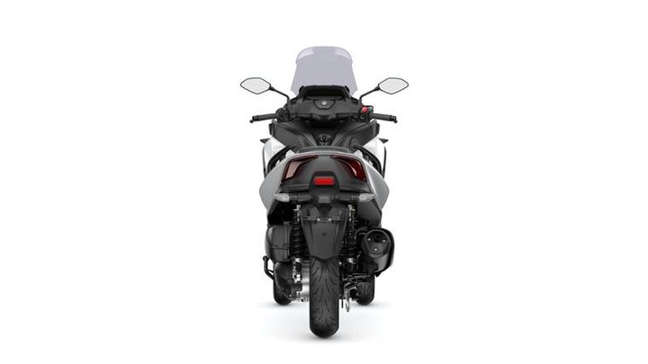 A rear view of a modern motorcycle with a sleek design, featuring a clear windshield, dual mirrors, and an integrated tail light. The motorcycle is positioned against a plain white background.