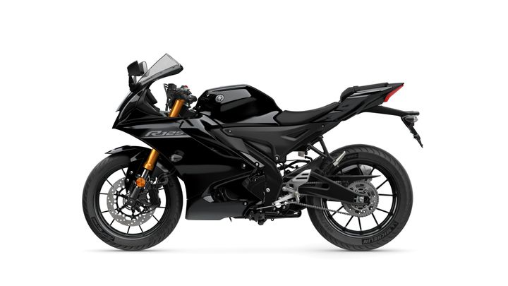 A sleek black sports motorcycle featuring a modern design, prominent fairings, and a distinctive front headlamp, positioned on a white background.