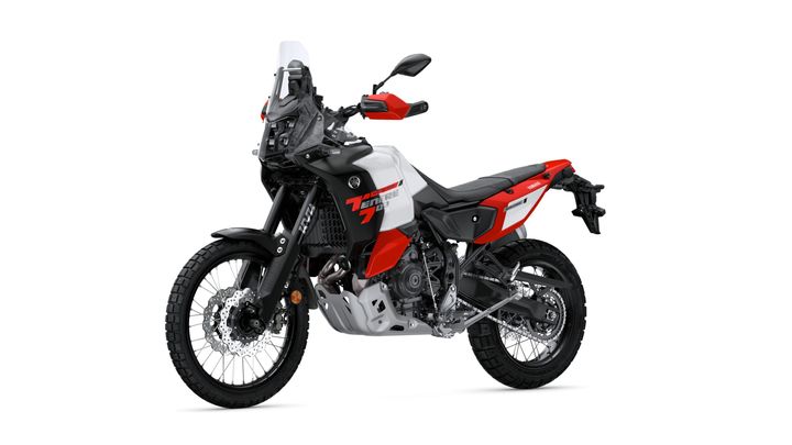 A Yamaha Tenere 700 motorcycle, featuring a black and red color scheme with rugged tires, is displayed against a white background.