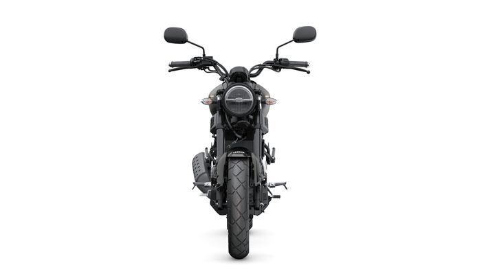 Front view of a black motorcycle with a round headlight, handlebars, and a thick tire, set against a white background.