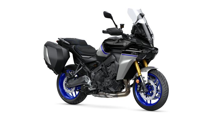 A black and silver Yamaha motorcycle with blue accents and a prominent windscreen, showcasing a sleek design and adventure-ready features, viewed from the side.