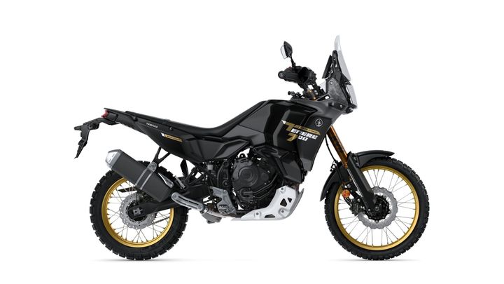 A black Yamaha Ténéré 700 motorcycle is displayed side-on, featuring gold accents on the wheels, a prominent windscreen, and rugged tires suitable for off-road adventures.