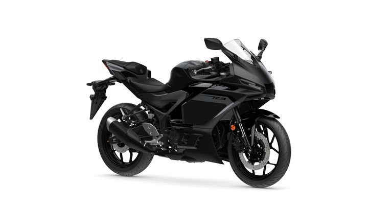 Yamaha 2025 R3 A sleek black Yamaha YZF-R3 motorcycle positioned at an angle, showcasing its aerodynamic design, front fairing, and sport-style frame.
