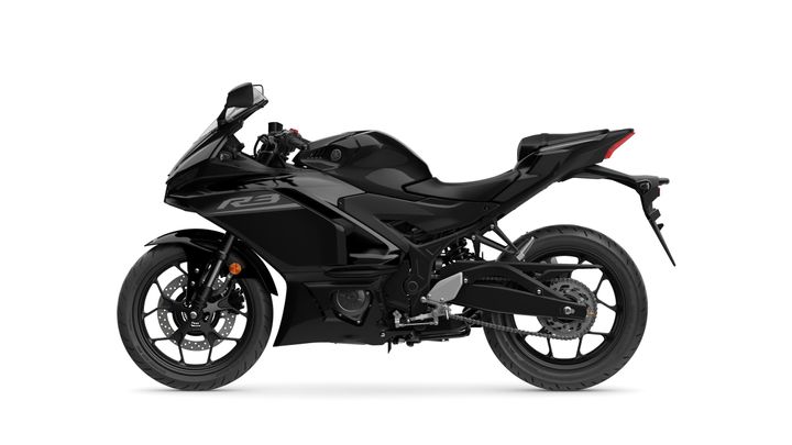 A sleek, black Yamaha R3 motorcycle is shown in profile, highlighting its aerodynamic design and sporty features.