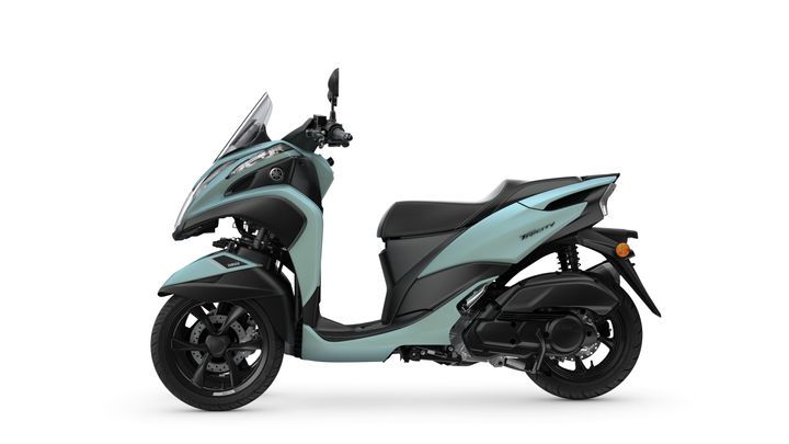 A sleek, aqua-colored Yamaha scooter is shown in profile, featuring a modern design with a stylish windshield, sporty wheels, and a comfortable seat.
