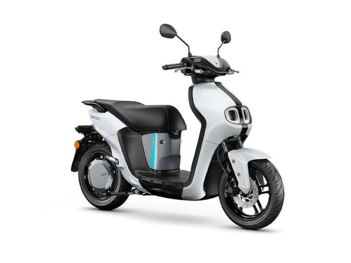 Yamaha 2023 Neos Dual Battery A modern electric scooter with a sleek white body, brown seat, black tires, and distinctive front headlights.