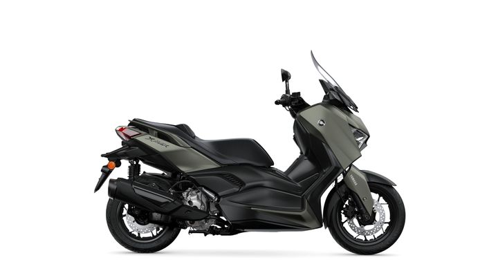 A sleek, modern scooter in matte green, featuring a step-through design, a prominent front windscreen, and a sporty profile.
