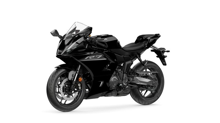A sleek black Yamaha R7 motorcycle positioned at a slight angle, showcasing its aerodynamic design and modern features.