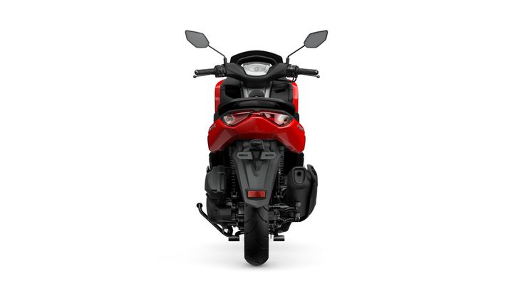 A red motorcycle viewed from the front, featuring a streamlined design, dual mirrors, and a prominent headlight. The background is plain white, highlighting the vehicle's details.