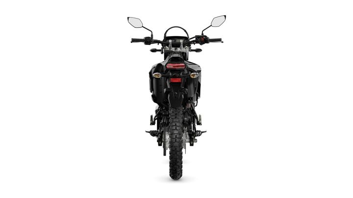 A rear view of a black off-road motorcycle featuring prominent headlights, a sleek body design, and rugged tires.