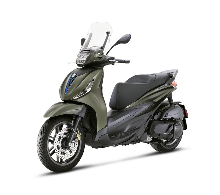 A modern olive green scooter with a windshield, featuring a sleek design, comfortable seat, and disc brakes, positioned on a white background.