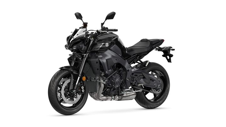 A sleek black motorcycle featuring a prominent front end, dual headlights, and sporty design elements, parked on a white background.