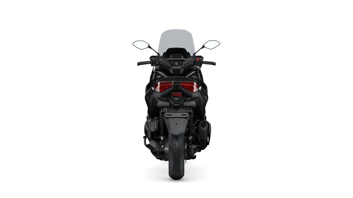 A rear view of a black motorcycle showcasing its sleek design, tail lights, and rear wheel, against a white background.