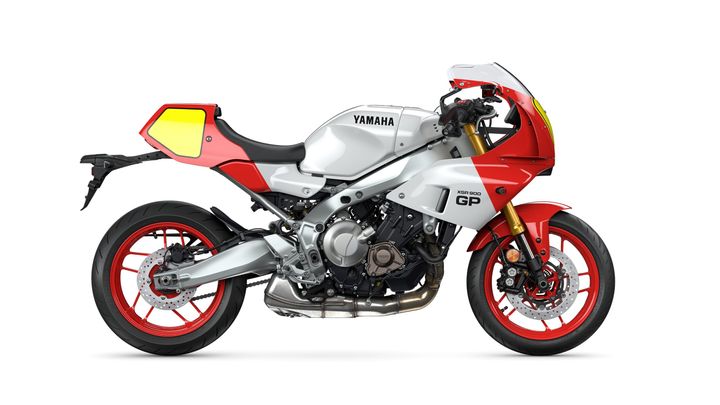 A side view of a Yamaha XSR900 GP motorcycle, featuring a sleek silver and red design with distinctive yellow accents, showcasing modern styling and performance features.