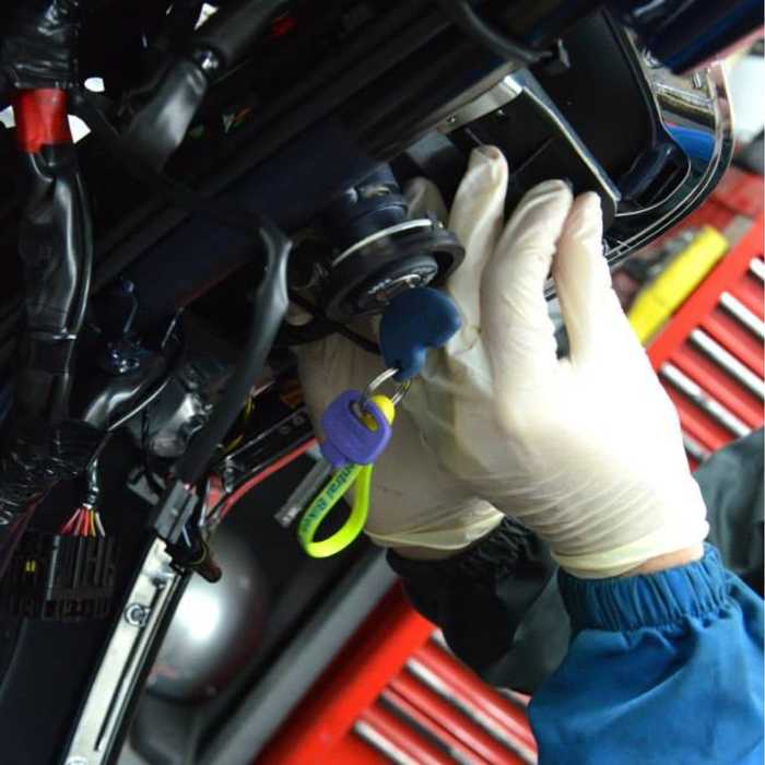 Motorcycle mechanic working on a bike engine
