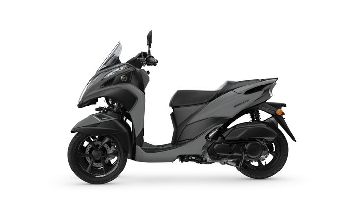 A sleek gray Yamaha scooter viewed from the side, showcasing its modern design, streamlined body, and distinctive wheel features.